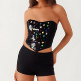 Black strapless top with colorful gemstones worn by a model